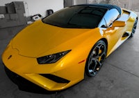 a yellow lamborghini parked in a garage