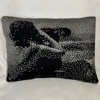 a black and white pillow with a woman on it