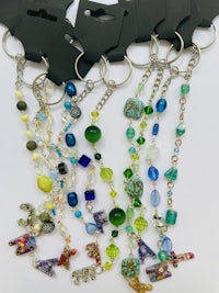 a group of keychains with colorful beads and charms