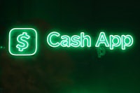 a green neon sign with the word cash app on it