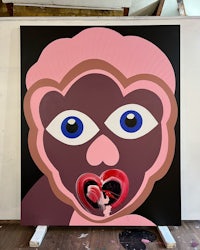 a painting of a pink monkey with blue eyes