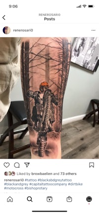 a tattoo of a motorcycle riding through the woods