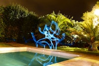 a swimming pool with a sculpture in it