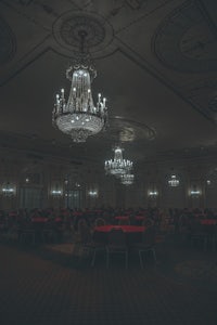a large room with tables and chandeliers