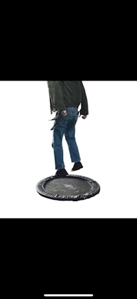 a man is standing on top of a trampoline