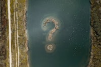 an aerial view of a lake with a question mark in the middle