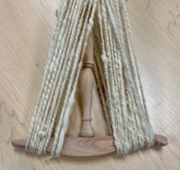 a skein of yarn on a wooden loom