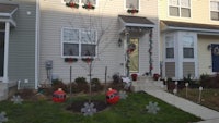 christmas decorations in front of a townhouse