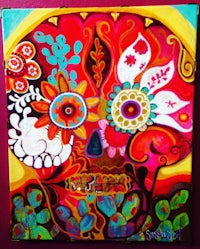 a colorful painting of a sugar skull on a wall