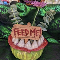 a bowl with a sign that says feed me