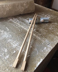 two wooden chopsticks sitting on top of a table