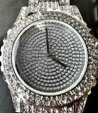 a silver watch with diamonds on it