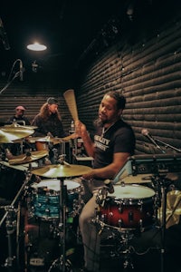 a man playing drums in a recording studio