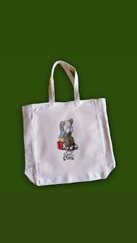 a white tote bag with an image of a koala