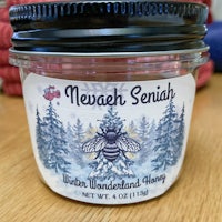 a jar of winter wonderland honey on a table