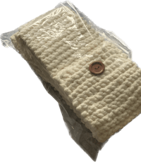 a white knitted bag with a button on it
