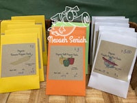 a variety of seed packets on a wooden table