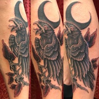 a tattoo of a raven with a crescent moon