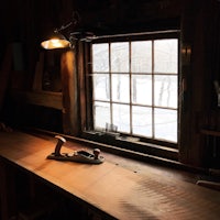 a wooden workbench in a room with a window