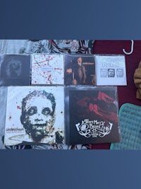 a collection of cds and other items on a bed