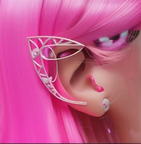 a close up of a pink haired girl with ear cuffs