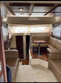 the interior of a motor yacht with a couch and tv