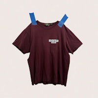 a maroon t - shirt with blue tape on it