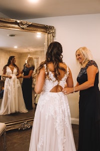 a bride getting ready in front of a mirror