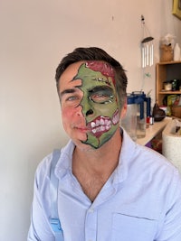 a man with a zombie face painted on his face