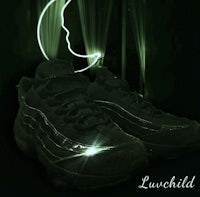 a pair of black sneakers with the word luvchild written on them