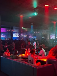 a group of people sitting in a bar