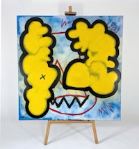 a yellow and black painting on an easel