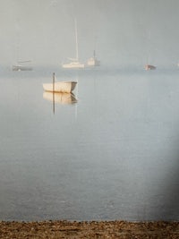 boats in the water on a foggy day