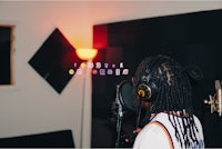 a person wearing headphones in a recording studio