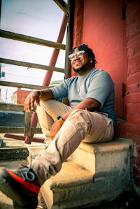 a man sitting on the steps of a building