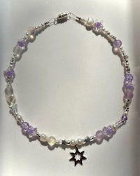 a purple and silver bracelet with a star charm