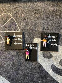 a group of pins with a message on them