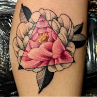 a tattoo with a pink flower and a triangle
