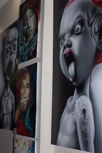a group of paintings on the ceiling of a shop
