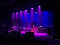 a stage in a dark room with purple lights