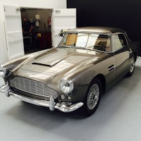 a classic aston martin parked in a garage