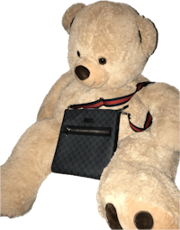 a large teddy bear sitting next to a purse