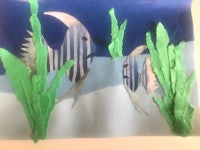 a piece of paper with fish and plants on it
