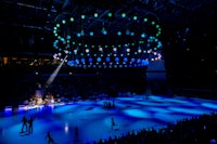 the ice rink is lit up with blue lights