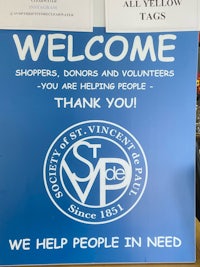 a sign that says welcome shoppers, donors and volunteers