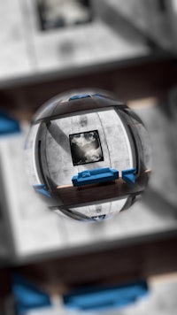 a blue couch is reflected in a sphere