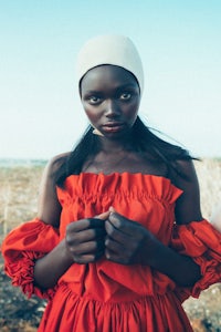 an african woman in a red dress posing for a photo