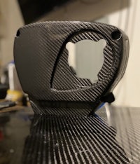 a black carbon fiber cover on a table