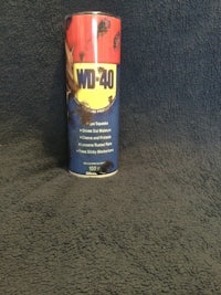 a can of lubricant sitting on top of a carpet
