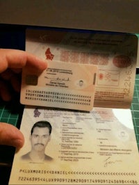 a person holding a passport with a stamp on it
